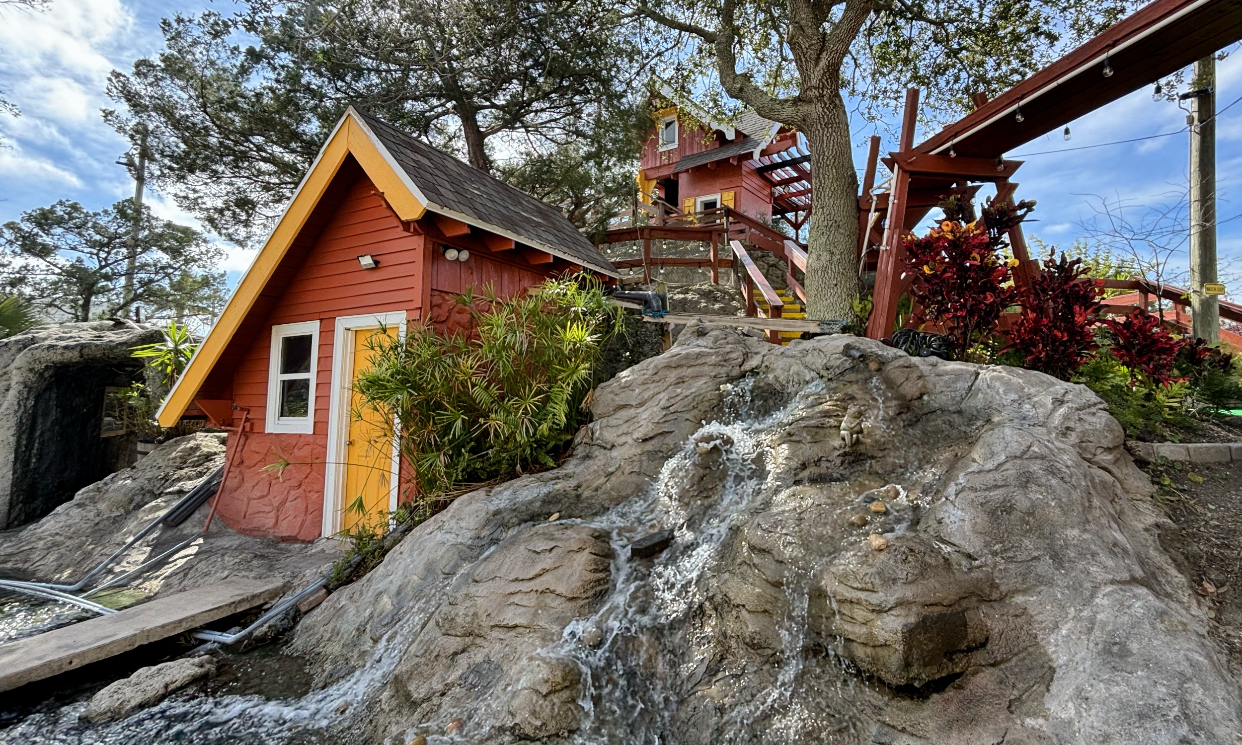 A waterfall and colorful huts at Anastasia Miniature Golf