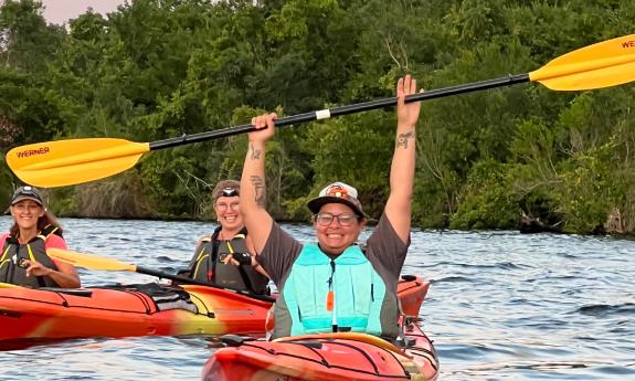 Three happy kayakers at the end of a fun and informative eco-tour with Earth Kinship
