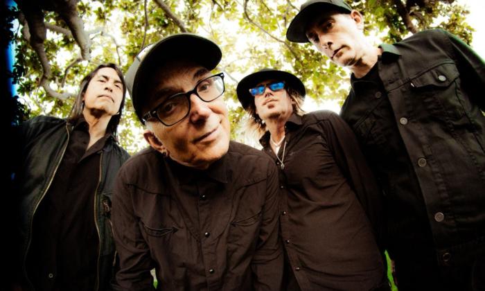 Bandmates from Everclear pose in front of a tree. 