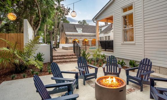 The firepit is surrounded by comfortable chairs