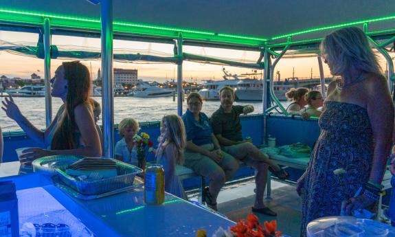 As the sun sets, a tour boat passes the bayfront