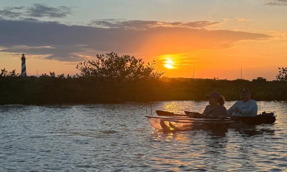 Kayakers paddling during sunset with sights of the Lighthouse