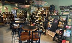 The wine collection lining the wall with umbrella decor hanging