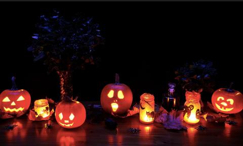 A row of candles and Jack-o-lanterns