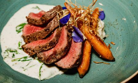 A beef dinner on a green plate