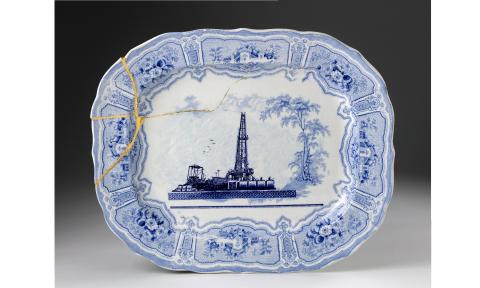 A blue transferware platter, cracked, and titled "Fracked"