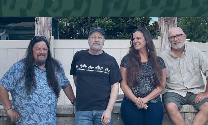 Saltones band sitting togeter in front of white fence