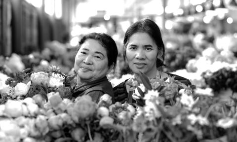 Women standing in a flower garden