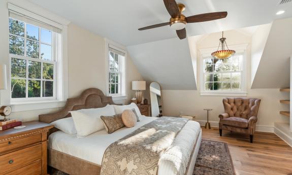 This bedroom on the second floor has charming window alcoves under the pitched roof
