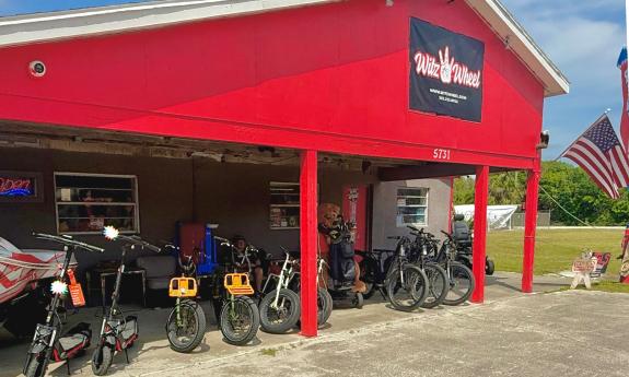 The bright red barn for Witz Wheel has an open bay with their rental e-vehicles lined up